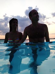 couple at dusk in water