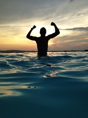 man in water at dusk