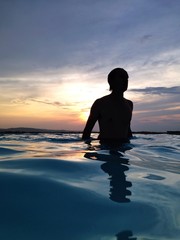 man in water at dusk