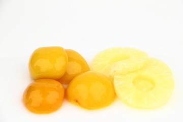 Peaches and pineapples on the white background