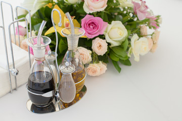 Oil and balsamic vinegar glass bottles with spouts on a banquet