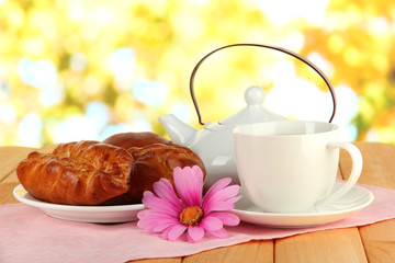 Cherry Pie with tea on table on bright background