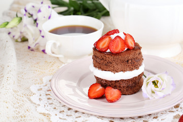 Chocolate cake with strawberry on table close-up