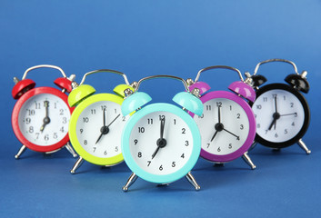 Colorful alarm clock on blue background
