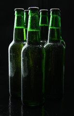 Bottles of beer on black background