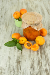 Apricot jam in glass jar and fresh apricots,