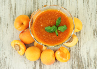 Apricot jam in glass bowl and fresh apricots,
