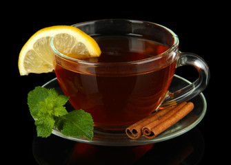 Cup of tea with lemon isolated on black