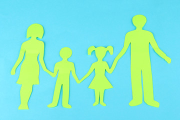 Family from paper on bright background