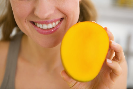 Closeup On Young Woman Showing Mango