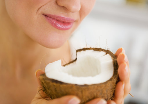 Closeup on young woman enjoying coconut