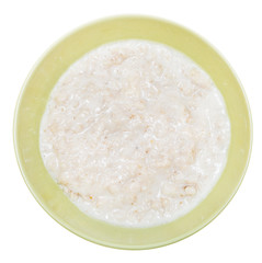oat porridge with milk in ceramic bowl