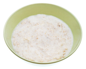 oat porridge with milk in ceramic bowl