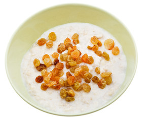 oat porridge with raisins in yellow bowl
