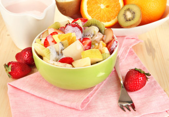Useful fruit salad of fresh fruits and berries in bowl