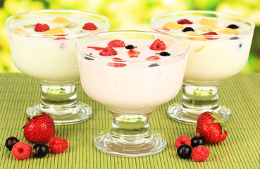 Delicious yogurt with fruit on table on bright background