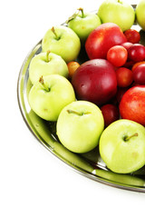 Assortment of juicy fruits on plate, isolated on white