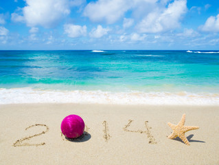 Fototapeta na wymiar Number 2014 on the sand - holiday concept