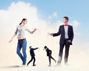 Businesspeople with marionettes
