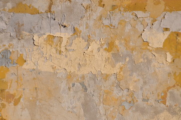 Old wall with peeling yellow paint