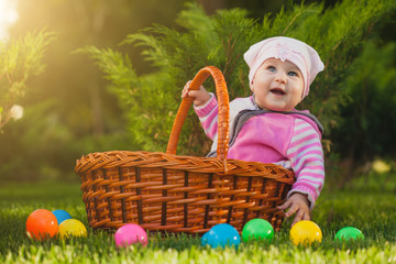 cute baby in basket in the green park