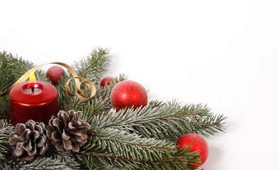 Red candle burning amongst twigs of the spruce