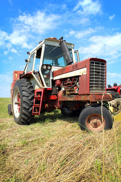 Old Farm Tractor in Grass Field