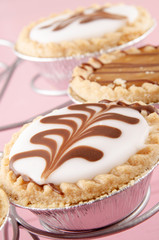 decorated tarts on a cake stand