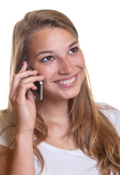Smiling young girl is happy about the news on the phone