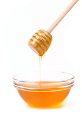 Bee honey with wooden dipper.