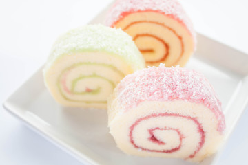 Colorful jam roll cakes  on white background