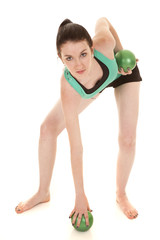 Fototapeta na wymiar woman green tank and balls grab off ground