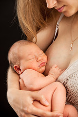 Young caucasian woman holding newborn son