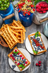 Waffles with fresh collected berry fruit