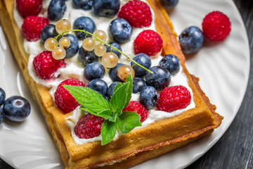 Waffels with cream and berry fruits