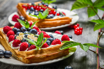 Waffels with cream and blueberry and raspberry
