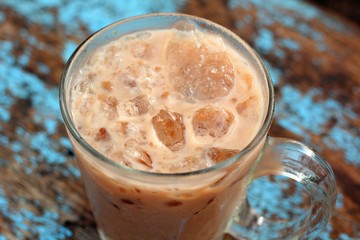 Cocoa in ice on wood background