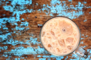 Cocoa in ice on wood background