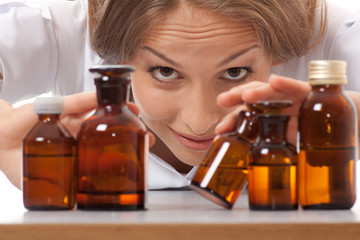 woman doctor with medication in glass bottles