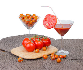 Tomato juice in the glass, orange cherry tomatoes and red tomato