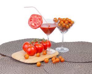 Tomato juice in the glass, orange cherry tomatoes and red tomato