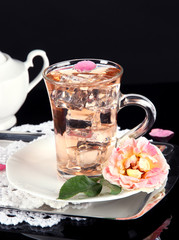 Glass cup of ice tea from tea rose