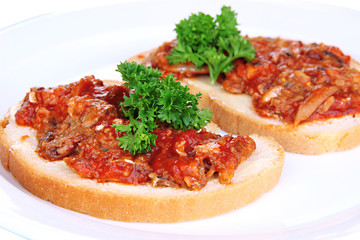 Tasty sandwiches with sardines  and tomato sauce, close-up