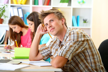 Group of young students sitting at the library