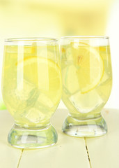 Delicious lemonade on table on light background
