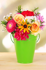 Beautiful bouquet of bright flowers in color vase,