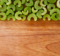 Row of chopped celery pieces against wood