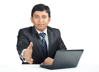 Cheerful Young Indian business man with Laptop