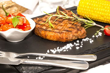 Grilled steak with sauce and greens 