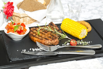 Grilled steak with sauce and greens 